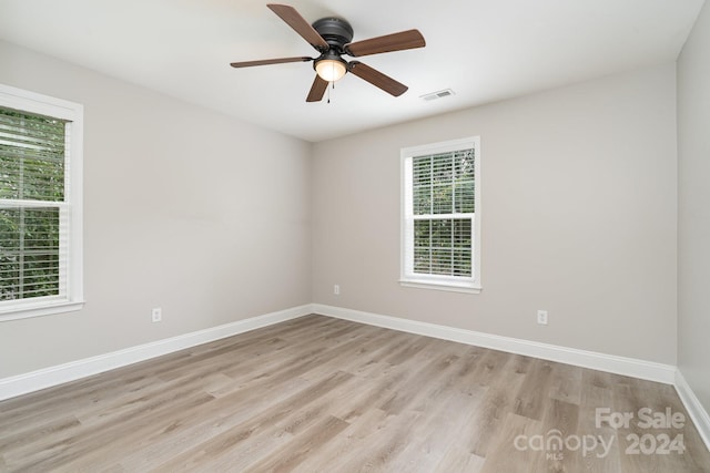 empty room featuring light hardwood / wood-style floors, ceiling fan, and plenty of natural light