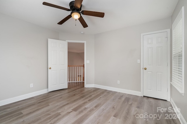 unfurnished bedroom featuring light wood-type flooring and ceiling fan