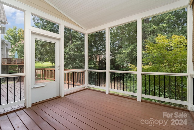 unfurnished sunroom featuring vaulted ceiling