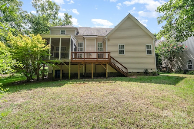 rear view of house with a lawn, a deck, and a sunroom