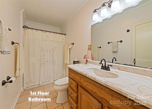 bathroom with toilet, ornamental molding, vanity, a textured ceiling, and tile patterned floors