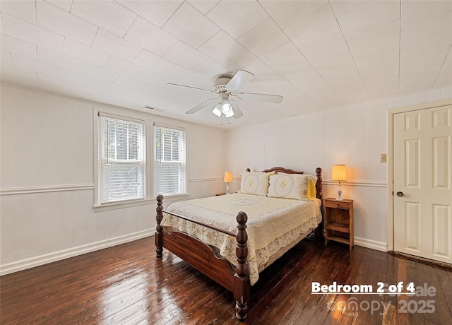 bedroom featuring wood-type flooring, visible vents, ceiling fan, and baseboards