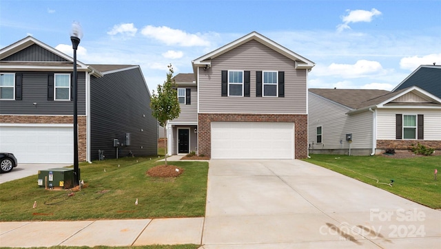 view of front of property with a front yard, a garage, and central AC unit