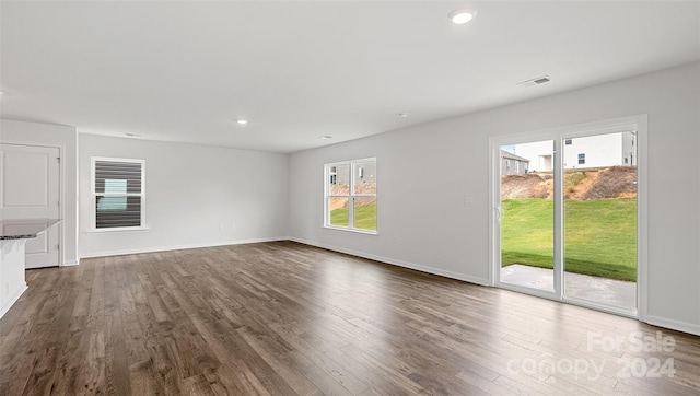 unfurnished living room featuring dark wood-type flooring