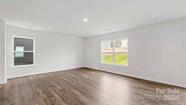 unfurnished room with wood-type flooring