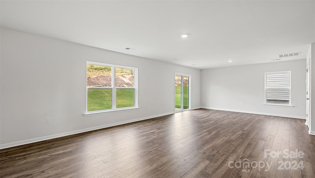 unfurnished room featuring dark wood-type flooring