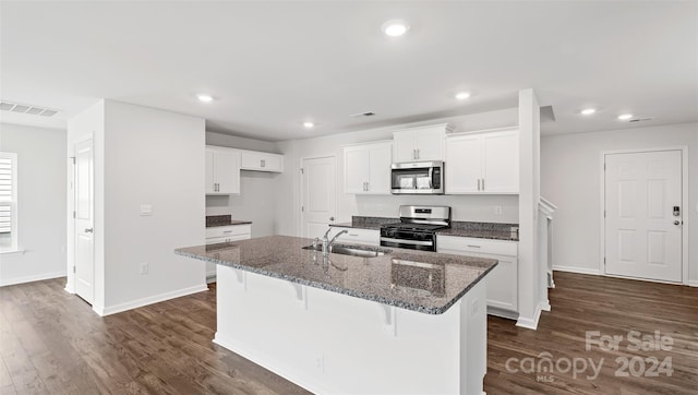 kitchen with white cabinets, sink, a kitchen island with sink, stainless steel appliances, and dark hardwood / wood-style floors