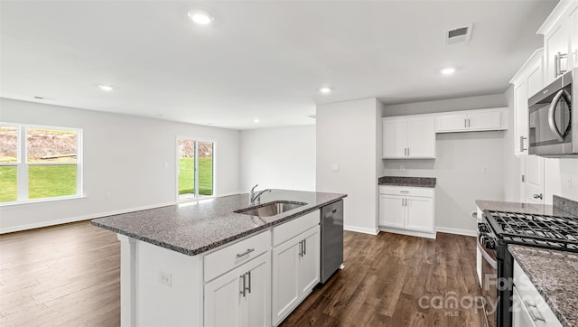 kitchen with sink, a center island with sink, white cabinetry, stainless steel appliances, and dark hardwood / wood-style flooring