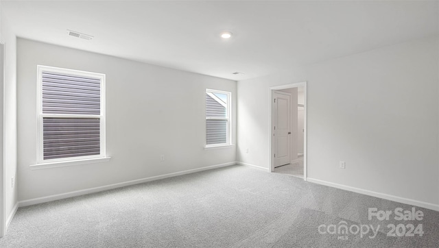 unfurnished room with light carpet