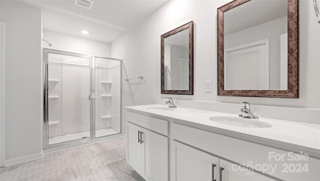 bathroom featuring vanity, tile patterned flooring, and an enclosed shower