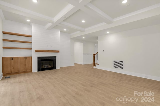 unfurnished living room with a fireplace, light hardwood / wood-style flooring, beamed ceiling, and coffered ceiling