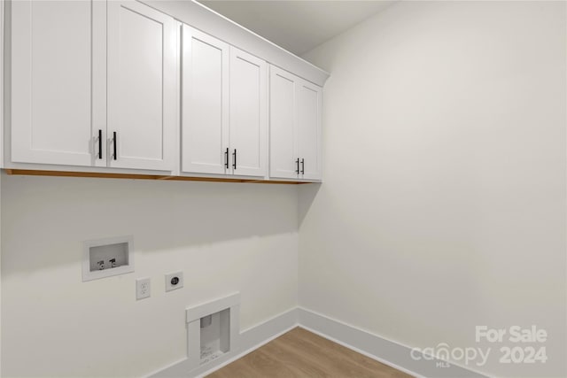 laundry room featuring light hardwood / wood-style floors, washer hookup, cabinets, and hookup for an electric dryer