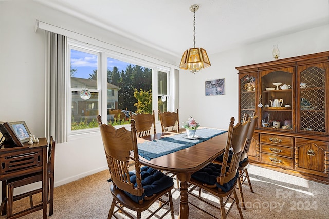 dining space with light colored carpet and a wealth of natural light