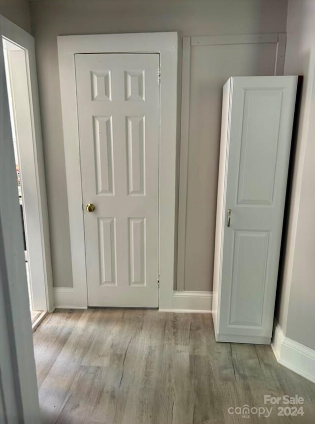 hall with light hardwood / wood-style floors