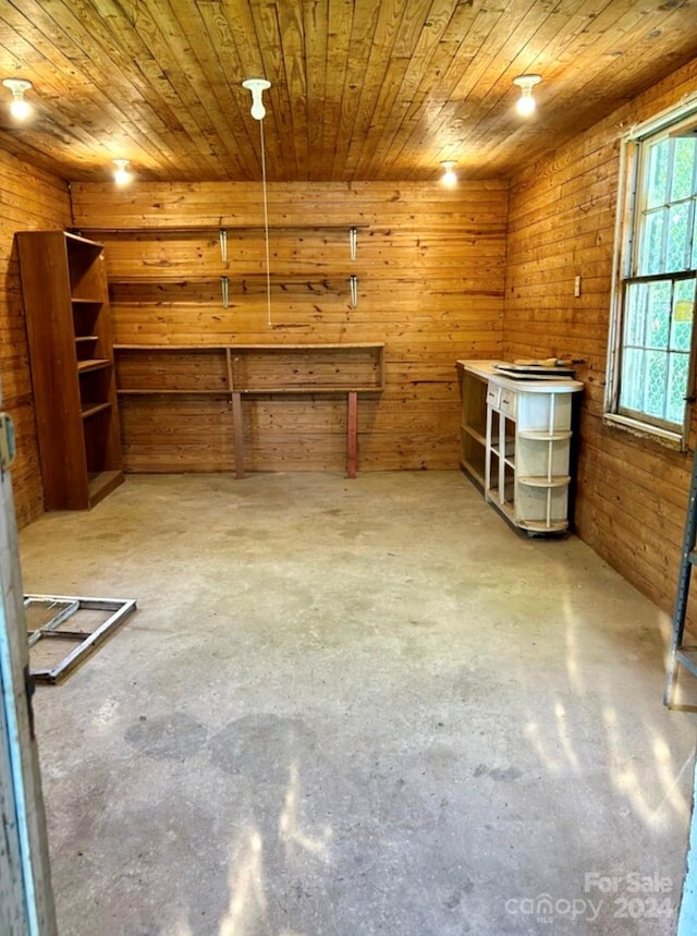 miscellaneous room featuring concrete flooring, wood ceiling, and wood walls