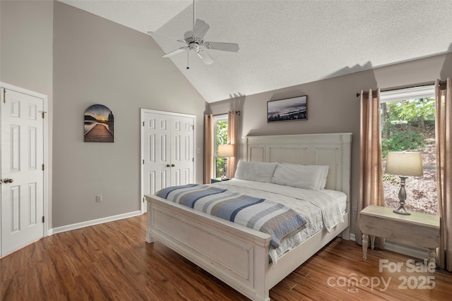 bedroom featuring ceiling fan, wood-type flooring, high vaulted ceiling, and a textured ceiling