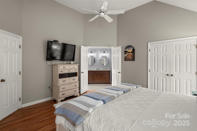 bedroom featuring ensuite bathroom, high vaulted ceiling, a closet, ceiling fan, and hardwood / wood-style floors