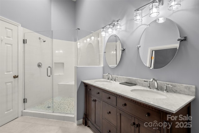 bathroom featuring tile patterned flooring, vanity, and walk in shower