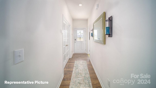 corridor featuring wood-type flooring