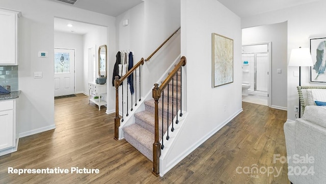 stairway with wood-type flooring