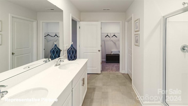 bathroom featuring vanity and an enclosed shower