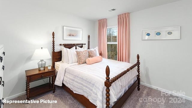 bedroom with dark colored carpet