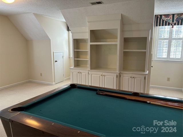 game room featuring vaulted ceiling, pool table, a textured ceiling, and carpet floors