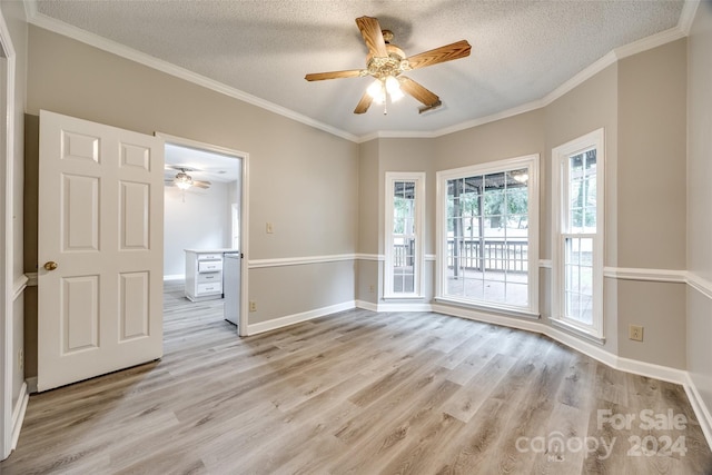 unfurnished room with ceiling fan, a textured ceiling, and light wood-type flooring