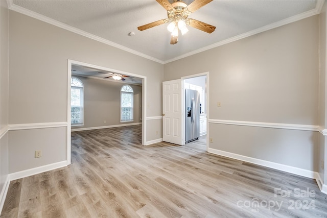 empty room with light hardwood / wood-style floors, ceiling fan, and crown molding