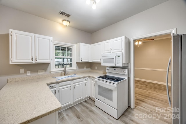 kitchen featuring light wood-type flooring, sink, white cabinets, white appliances, and ceiling fan