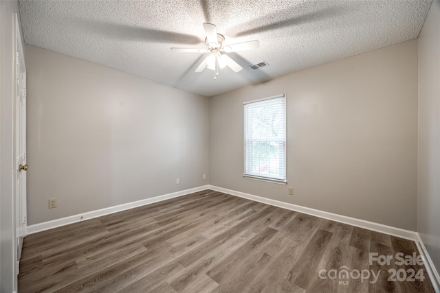 spare room featuring ceiling fan, a textured ceiling, and hardwood / wood-style floors