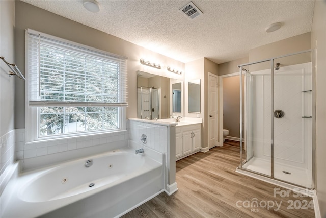 full bathroom featuring independent shower and bath, vanity, toilet, and hardwood / wood-style flooring