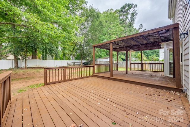 wooden deck with a storage shed and a pergola