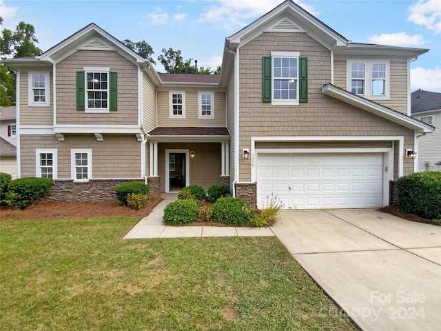 view of front facade featuring a front yard and a garage