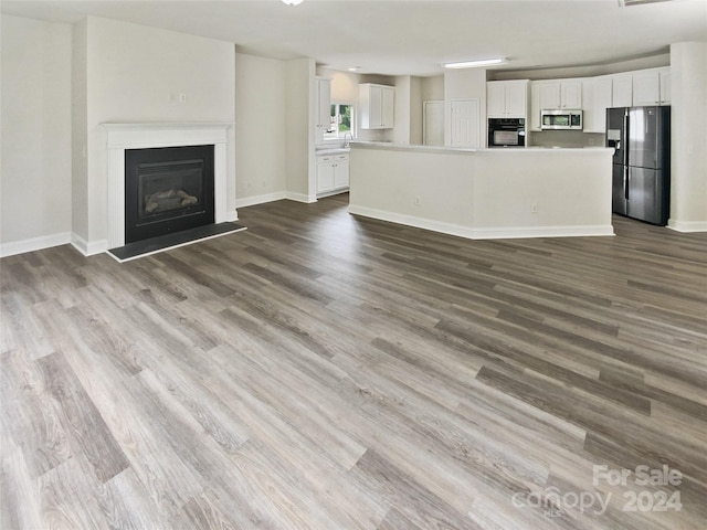 unfurnished living room featuring dark wood-type flooring