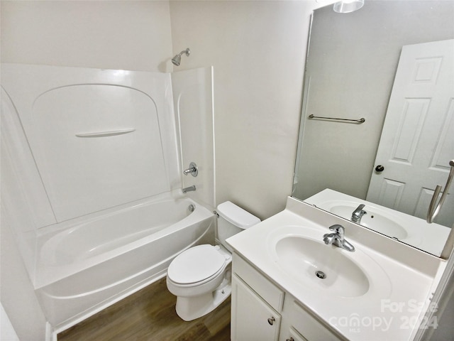 full bathroom with hardwood / wood-style floors,  shower combination, vanity, and toilet