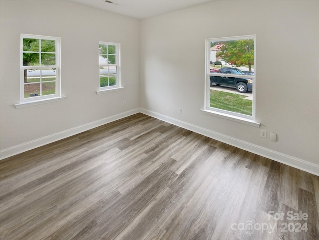 unfurnished room featuring hardwood / wood-style flooring