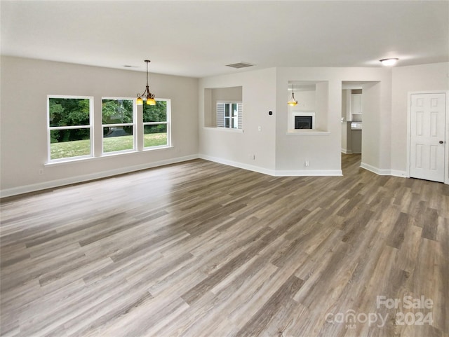 unfurnished living room with hardwood / wood-style floors