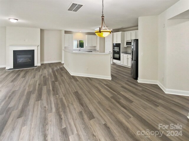 unfurnished living room featuring dark hardwood / wood-style flooring and sink