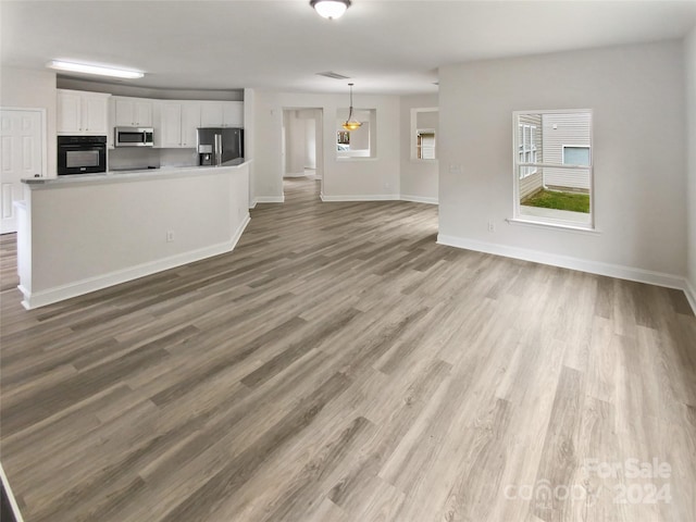 unfurnished living room with hardwood / wood-style floors