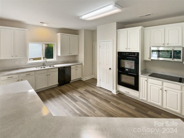 kitchen featuring black appliances, white cabinetry, and sink