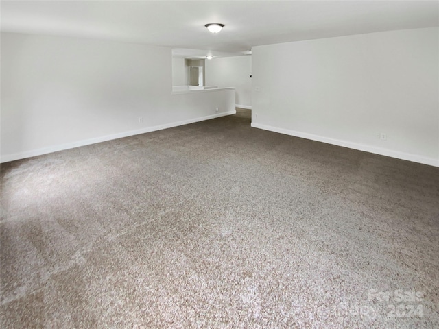 empty room with dark colored carpet