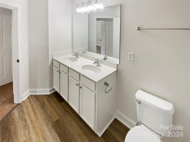 bathroom featuring hardwood / wood-style flooring, vanity, and toilet