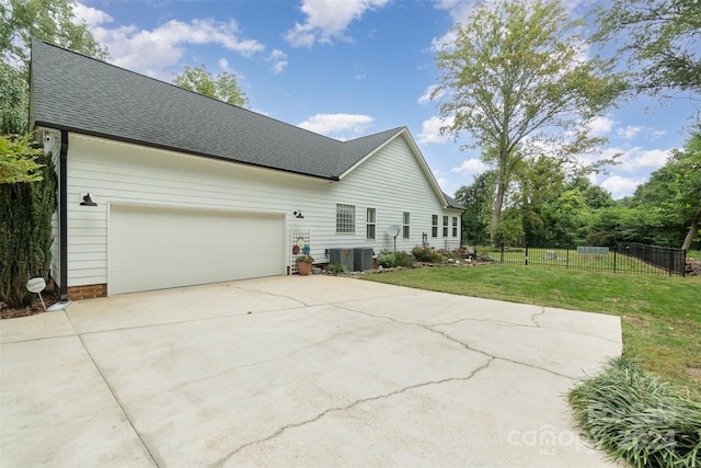 view of home's exterior featuring a lawn and a garage