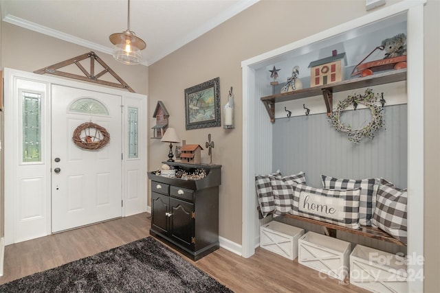 entrance foyer with crown molding and hardwood / wood-style floors