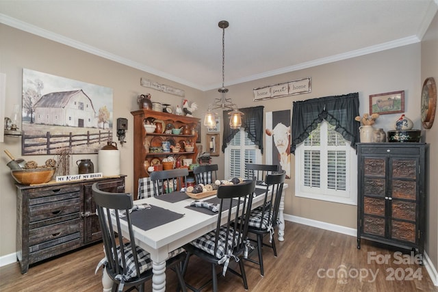 dining room with wood-type flooring, an inviting chandelier, and ornamental molding