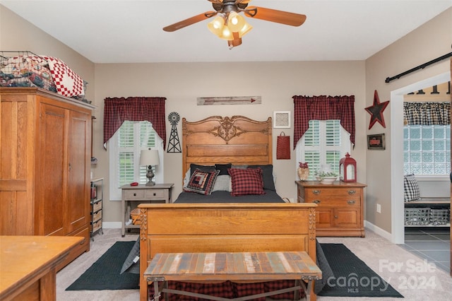 bedroom featuring ceiling fan and light colored carpet