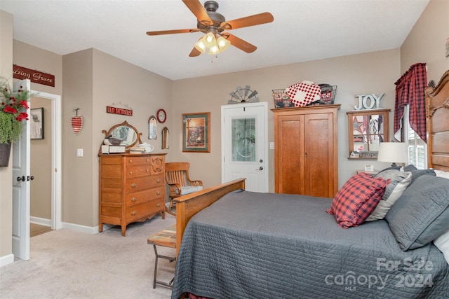 bedroom with ceiling fan and light colored carpet