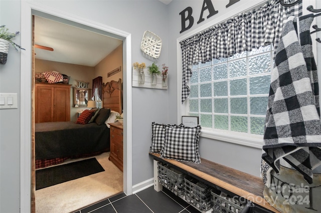 bathroom with ceiling fan and tile patterned floors