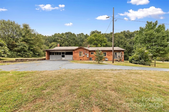 single story home with a front yard and a carport